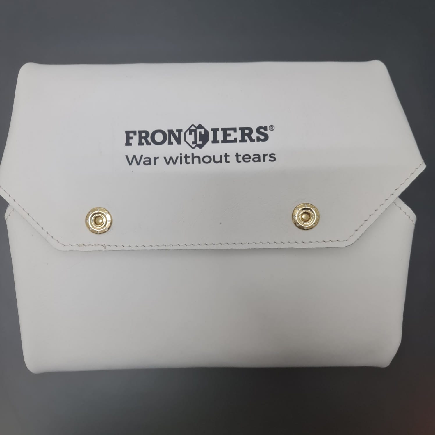 White leather FRONTIERS board folded as a case during product development.
